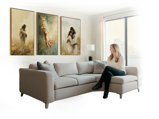 Christian woman sitting on a sofa and enjoying 3 pieces of Christian wall art on her wall
