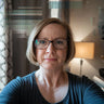 a 50 year old looking blonde woman with glasses that left a review about christian art